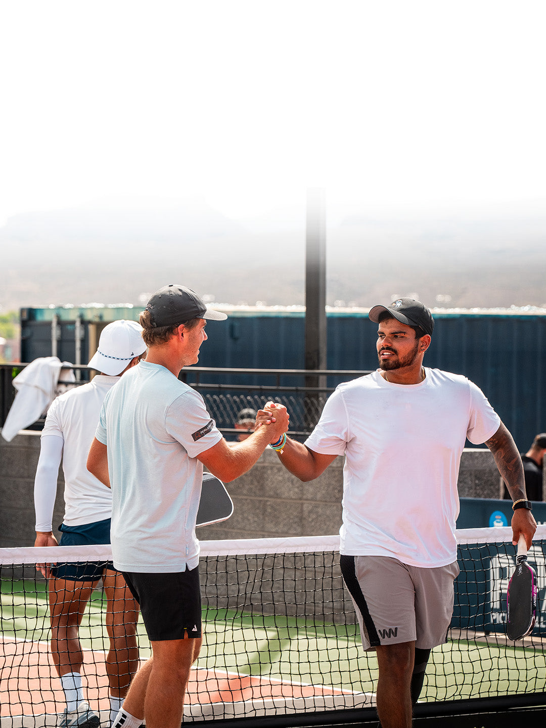 Pickleball players using Warping Point paddles on the court